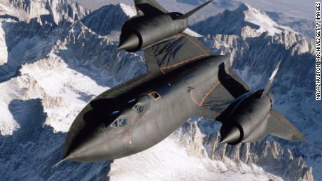 SR-71B Blackbird aerial reconnaissance aircraft photographed over snow capped mountains in 1995.