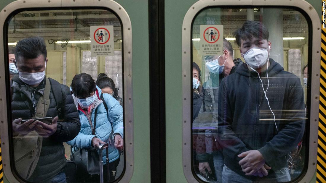 Passengers in Hong Kong wear protective masks as they wait to board a train at Lo Wu Station, near the mainland border, on January 30. 